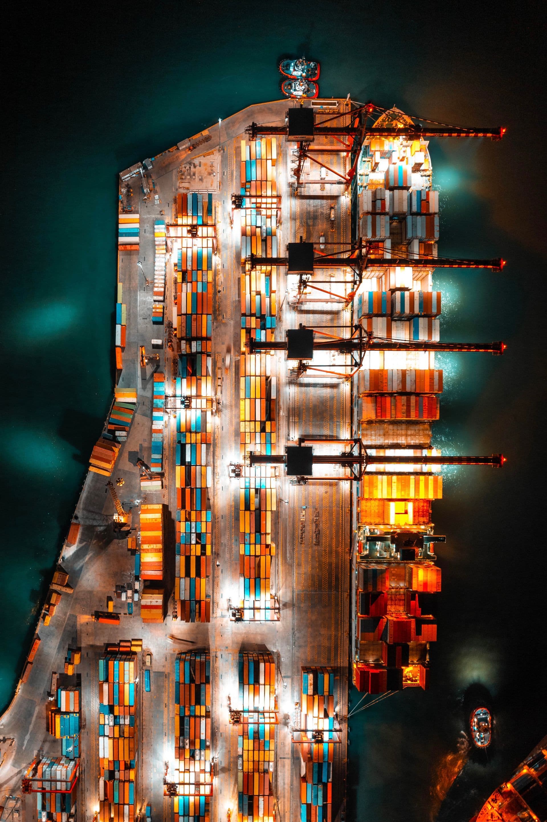 Aerial view of a container port at night, freight ready to move